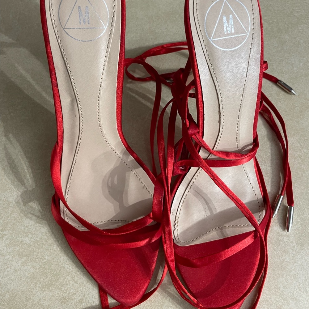 Pointed lace up red heels . Wore twice for a short outing.
